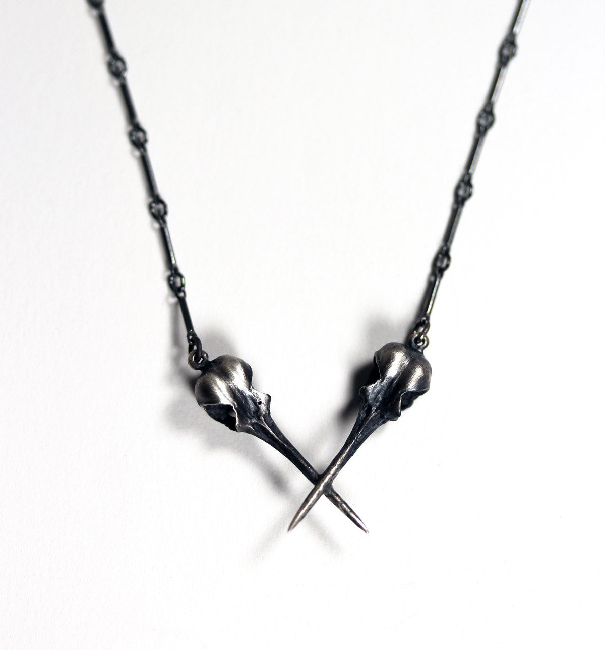 The AfterLife Part II. Crossed sterling hummingbird skulls.